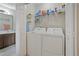 Laundry room with white washer and dryer with wire shelf storage at 210 Cottonwood Creek Cir, Canton, GA 30114