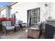 Inviting patio with comfortable seating, flowering bushes, and sliding door access to the home's interior at 210 Cottonwood Creek Cir, Canton, GA 30114