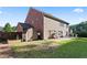 Backyard featuring a shed, patio, and partially fenced in yard surrounded by mature trees at 211 Parc Dr, Canton, GA 30114