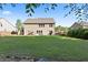 Large backyard featuring a shed, patio, swing, mature trees, and level landscaping at 211 Parc Dr, Canton, GA 30114