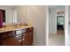 Bathroom featuring dark wood vanity cabinet, light countertop, and doorway to a bedroom at 211 Parc Dr, Canton, GA 30114