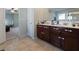 Bright bathroom featuring a double sink vanity with granite countertops and tile flooring at 211 Parc Dr, Canton, GA 30114