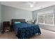 Bright, airy bedroom with a leafy patterned bedspread, neutral walls, and a sunlit window and workspace at 211 Parc Dr, Canton, GA 30114