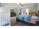 Large primary bedroom showcasing a tray ceiling, stylish furniture, and view to bedroom next door at 211 Parc Dr, Canton, GA 30114