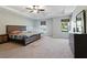 Spacious primary bedroom with a tray ceiling, stylish furnishings, and plentiful natural light at 211 Parc Dr, Canton, GA 30114