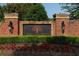 Attractive brick entrance to The Park at Steels Bridge community, landscaped with greenery and flowers at 211 Parc Dr, Canton, GA 30114