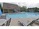Community pool with plenty of lounge chairs and umbrellas for residents to relax and enjoy at 211 Parc Dr, Canton, GA 30114