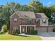 Beautiful two-story brick home with a well-manicured lawn and attached two car garage at 211 Parc Dr, Canton, GA 30114