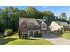 Attractive two-story brick home with well-manicured lawn and a three-car garage at 211 Parc Dr, Canton, GA 30114