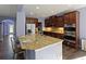 Modern kitchen island featuring granite countertop and stainless steel appliances at 211 Parc Dr, Canton, GA 30114