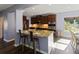 Gourmet kitchen features granite counters, stainless appliances, and breakfast bar seating at 211 Parc Dr, Canton, GA 30114