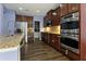 Chef's kitchen equipped with stainless steel appliances, gas cooktop and beautiful cabinetry at 211 Parc Dr, Canton, GA 30114