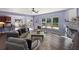 Bright living room features fireplace, dining area, and large windows overlooking the backyard at 211 Parc Dr, Canton, GA 30114