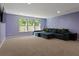 Large living room features natural light, a comfortable sectional, and plush carpet flooring at 211 Parc Dr, Canton, GA 30114
