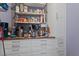 Pantry with bright white shelving, drawers, and cabinets offering abundant storage space at 211 Parc Dr, Canton, GA 30114