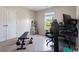 Spare room with a workout bench, gaming station, and a door leading outside to a view at 211 Parc Dr, Canton, GA 30114