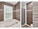Spacious bathroom featuring a large bathtub, separate shower, and stylish tilework at 3910 Meeting St, Duluth, GA 30096