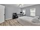 This bedroom offers a spacious layout, complemented by modern wood flooring and a ceiling fan for added comfort at 3910 Meeting St, Duluth, GA 30096