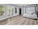 This spacious bedroom features a stylish canopy bed, modern floors, and large windows, inviting natural light at 3910 Meeting St, Duluth, GA 30096