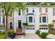 Attractive townhome showcases a stylish facade, well-maintained landscaping, and attached garage at 3910 Meeting St, Duluth, GA 30096