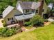 Aerial view of the home with manicured lawn, mature trees, brick patio and inviting backyard at 4930 Forestglade Ct, Tucker, GA 30087