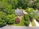 Aerial view of a home surrounded by lush trees and a well-maintained front yard at 4930 Forestglade Ct, Tucker, GA 30087