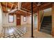 Unfinished basement with a tiled floor, exposed ceiling, and stairwell at 4930 Forestglade Ct, Tucker, GA 30087