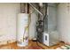 Basement featuring a water heater, HVAC system, and concrete flooring, providing essential utilities at 4930 Forestglade Ct, Tucker, GA 30087