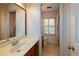 Bathroom with a single sink vanity, neutral walls, and window at 4930 Forestglade Ct, Tucker, GA 30087