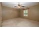 Neutral bedroom featuring a ceiling fan and a window, with carpeted floors at 4930 Forestglade Ct, Tucker, GA 30087