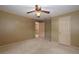 Neutral bedroom with a ceiling fan and doorways at 4930 Forestglade Ct, Tucker, GA 30087