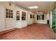 Relaxing covered brick patio with white trim, ceiling fan, and lush landscaping at 4930 Forestglade Ct, Tucker, GA 30087
