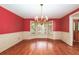 Elegant dining room with hardwood floors, bay windows, and chandelier at 4930 Forestglade Ct, Tucker, GA 30087