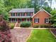 Charming two-story brick home with a welcoming front porch and well-manicured landscaping at 4930 Forestglade Ct, Tucker, GA 30087