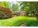 Beautifully landscaped front yard with lush green grass and mature trees surrounding the home at 4930 Forestglade Ct, Tucker, GA 30087