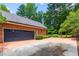 Side view of a two-car garage with an automatic door and extended driveway at 4930 Forestglade Ct, Tucker, GA 30087