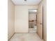 Hallway view with a doorway to a staircase, carpeted floor, and textured walls at 4930 Forestglade Ct, Tucker, GA 30087