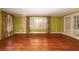 Sunlit living room with hardwood floors, large windows, and elegant curtains at 4930 Forestglade Ct, Tucker, GA 30087
