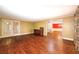 Open living room featuring hardwood floors, neutral walls, and decorative trim with access to additional room at 4930 Forestglade Ct, Tucker, GA 30087