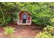 Backyard shed nestled among mature trees, offering extra storage or a private retreat at 4930 Forestglade Ct, Tucker, GA 30087