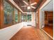Relaxing sunroom with brick floor, wood ceiling, and windows overlooking the lush greenery at 4930 Forestglade Ct, Tucker, GA 30087