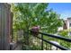 Cozy balcony with metal railing and a view of the beautiful green trees, flowers, and blue sky at 1300 Dekalb Ne Ave # 731, Atlanta, GA 30307