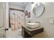 Bathroom featuring unique vanity with square vessel sink, patterned shower curtain, and round mirror at 1300 Dekalb Ne Ave # 731, Atlanta, GA 30307