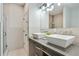 Modern bathroom with double vanity, square vessel sinks, walk-in shower, and tiled walls at 1300 Dekalb Ne Ave # 731, Atlanta, GA 30307