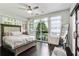 Bedroom with large windows, balcony access, ceiling fan, and stylish décor at 1300 Dekalb Ne Ave # 731, Atlanta, GA 30307