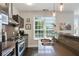 Kitchen boasts stainless steel appliances, sink, and peninsula with modern decor and dark floors at 1300 Dekalb Ne Ave # 731, Atlanta, GA 30307