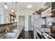 Kitchen boasts stainless steel appliances, stove, sink, and modern dark cabinets and dark floors at 1300 Dekalb Ne Ave # 731, Atlanta, GA 30307