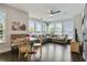 Bright living room boasts many windows, dark floors, ceiling fan, and neutral colored L-shaped couch at 1300 Dekalb Ne Ave # 731, Atlanta, GA 30307