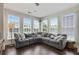 Bright living room boasts many windows and neutral colored L-shaped couch with patterned pillows at 1300 Dekalb Ne Ave # 731, Atlanta, GA 30307