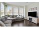 Bright living room boasts many windows and neutral colored L-shaped couch and fireplace at 1300 Dekalb Ne Ave # 731, Atlanta, GA 30307